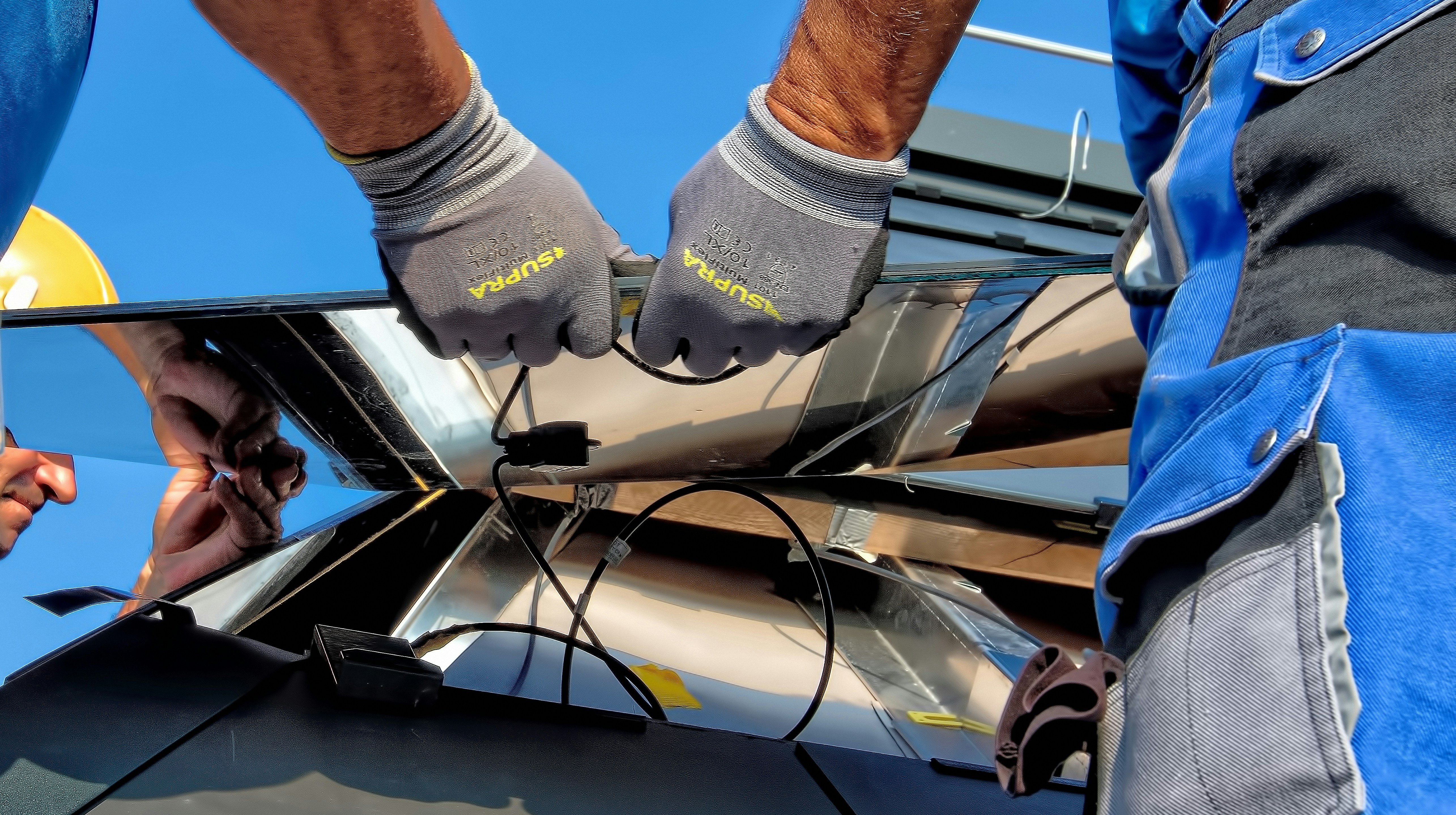 image of 2 workers carrying a solar panel